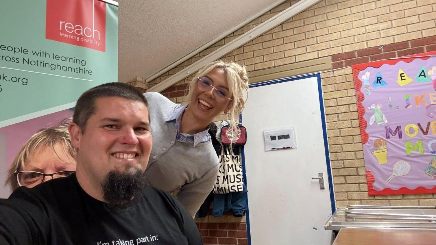 Jonny smiling with the barber before having his renowned beard shaved off at the Great Shave Off fundraiser.
