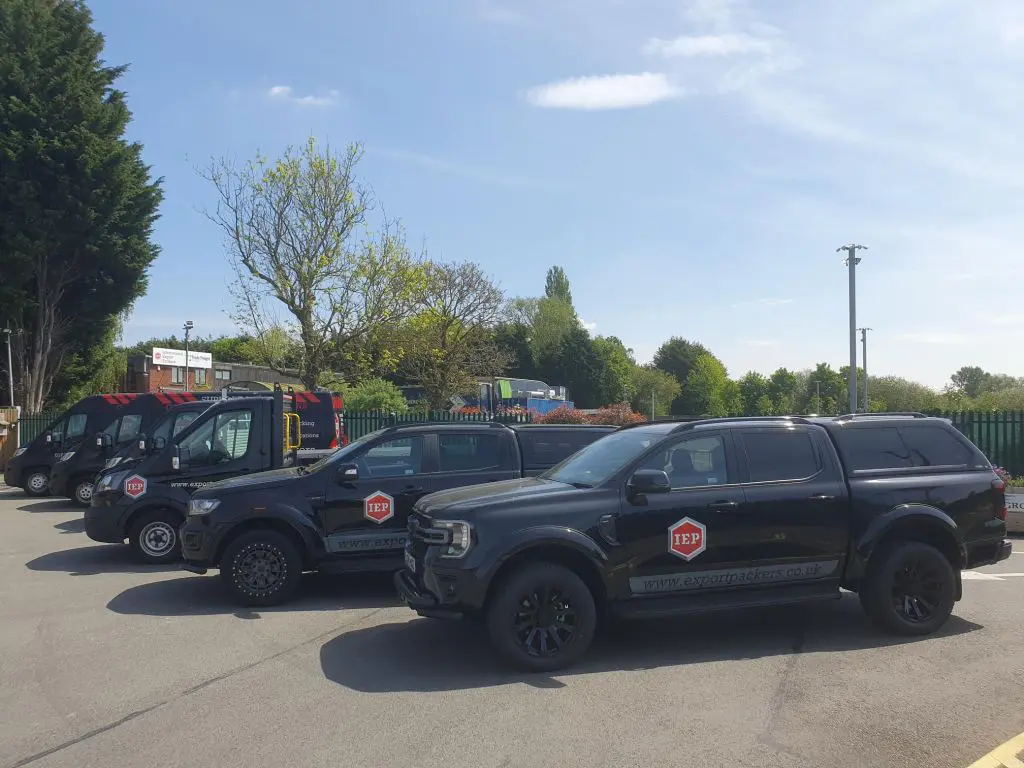 Fleet of International Export Packers vans ready for mobile on-site packing services, specialising in secure, professional packing of fragile, oversized, and Out of Gauge (OOG) shipments.