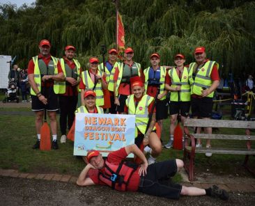 International Export Packers team taking part in the Newark Dragon Boat Festival on the River Trent, celebrating teamwork and community involvement.