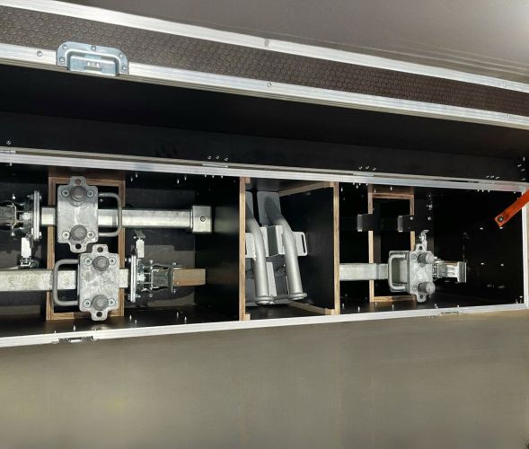 Interior of a bespoke Formula 1 flight case showing modular compartments for secure storage of car accessories.