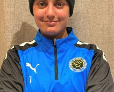 Olivia Valentine, a young goalkeeper sponsored by International Export Packers, in football kit preparing for her move to the USA to play college soccer.